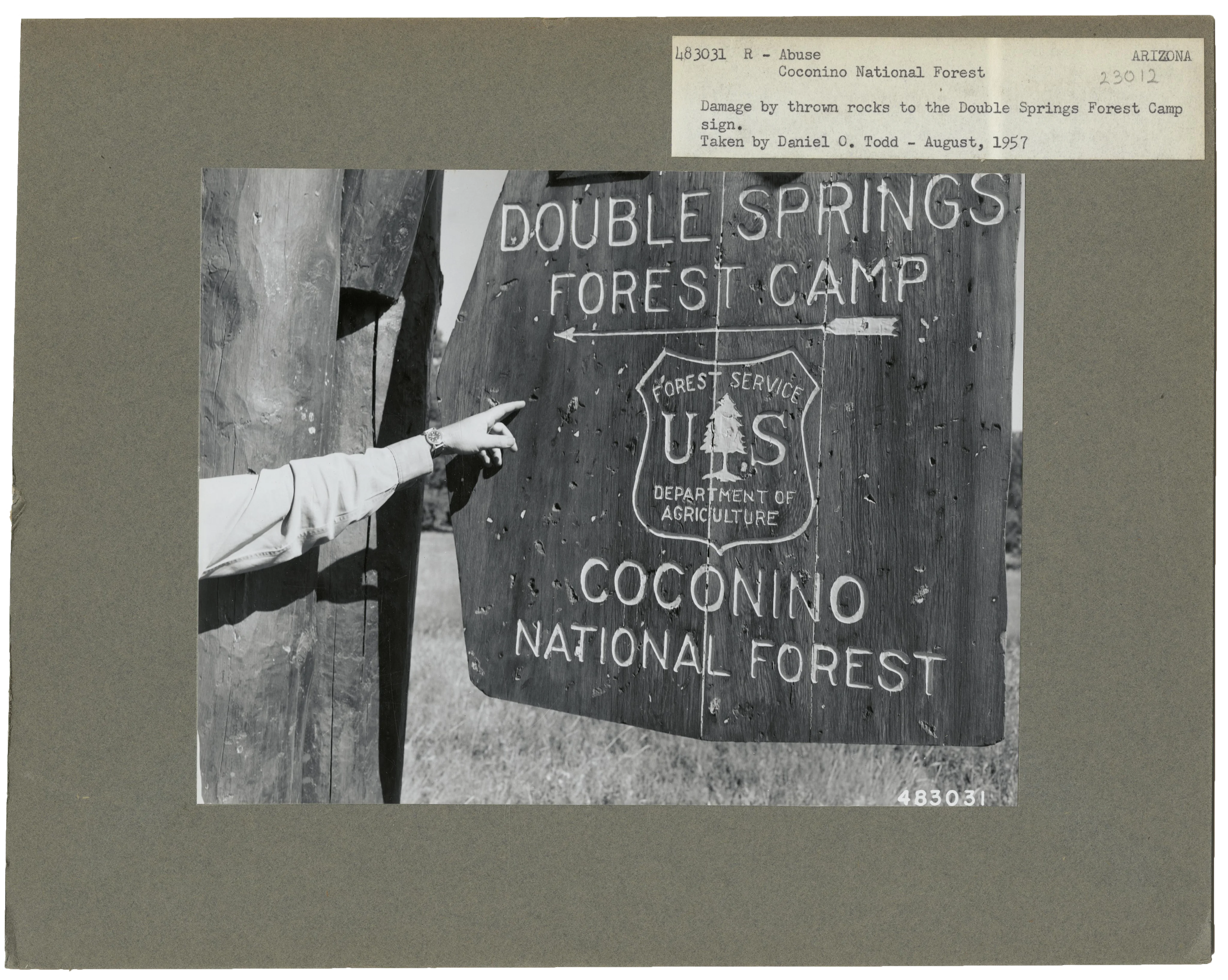 Sign damaged by thrown rocks