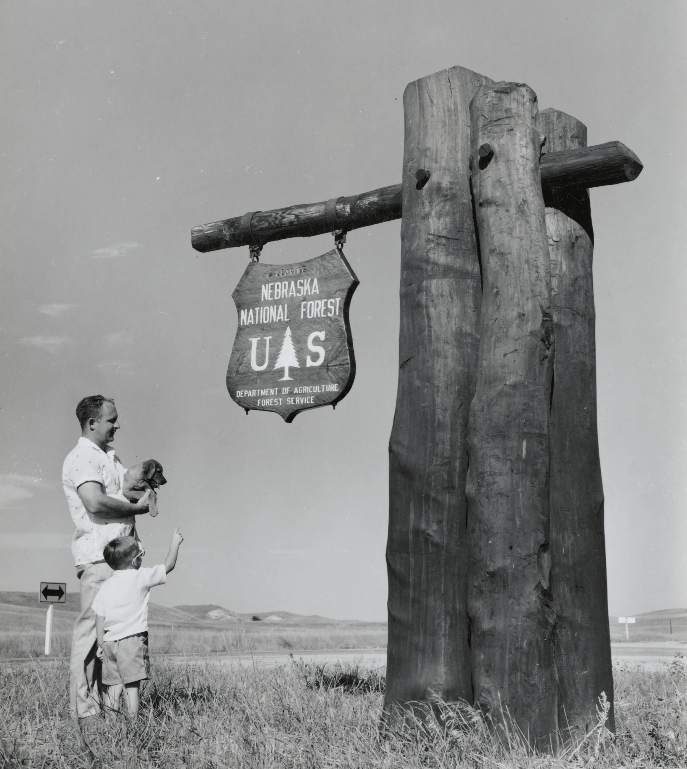 Father and Son at the National Forest entrance sign at Bessey Nursery